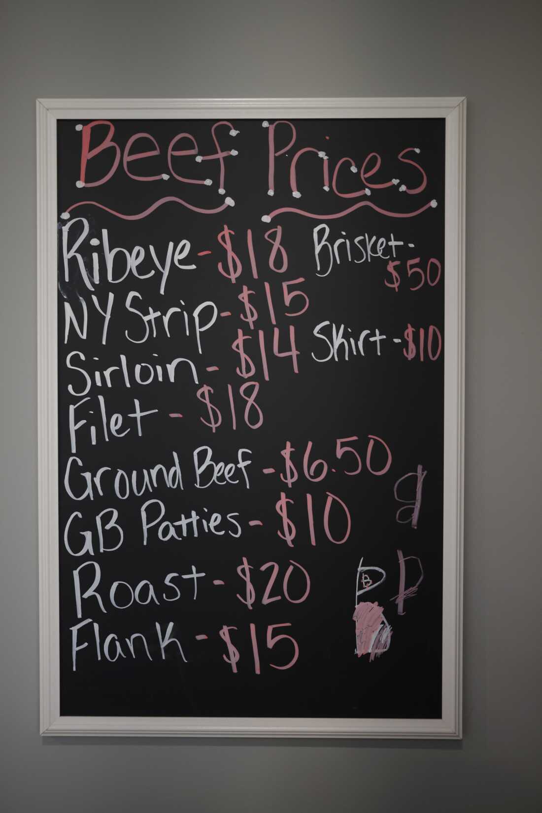 A chalkboard with handwritten beef prices is seen at Hallstead Farms. Prices range from $50 for brisket to $6.50 for ground beef.