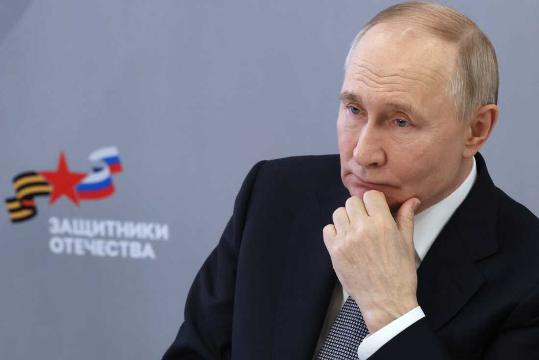 In a photograph distributed by the Russian state agency Sputnik, Russia's President Vladimir Putin meets in Moscow on March 6, 2025, with workers and wards of the Defenders of the Fatherland State Fund, the foundation supporting veterans of the Russian invasion of Ukraine.