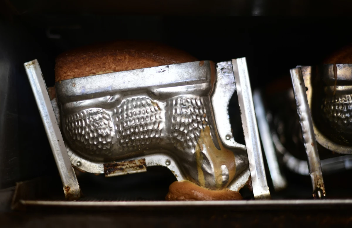 A baking form with traditional Easter cakes shaped as lambs is seen in an oven at the bakery Schuerener Backparadies in Dortmund, western Germany, on April 8, 2020.