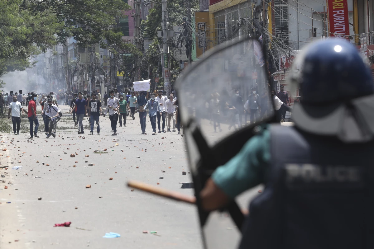 Students clash with riot police during a protest against a quota system for government jobs, in Dhaka, Bangladesh, Thursday, July 18, 2024.
