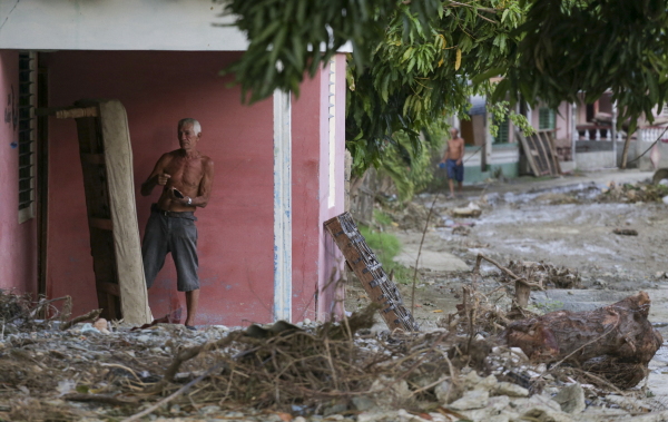 A man dries a mattress after Hurricane Oscar hit the town of Imias in Guantanamo province, Cuba, on October 30, 2024. Oscar strengthened from a depression to a hurricane in just five hours.