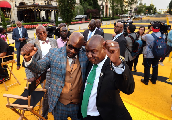 Philonise Floyd (left), George Floyd's brother, embraces Floyd family attorney Ben Crump as the family visits Black Lives Matter Plaza on on May 25, 2021, the one-year anniversary of George Floyd's death.