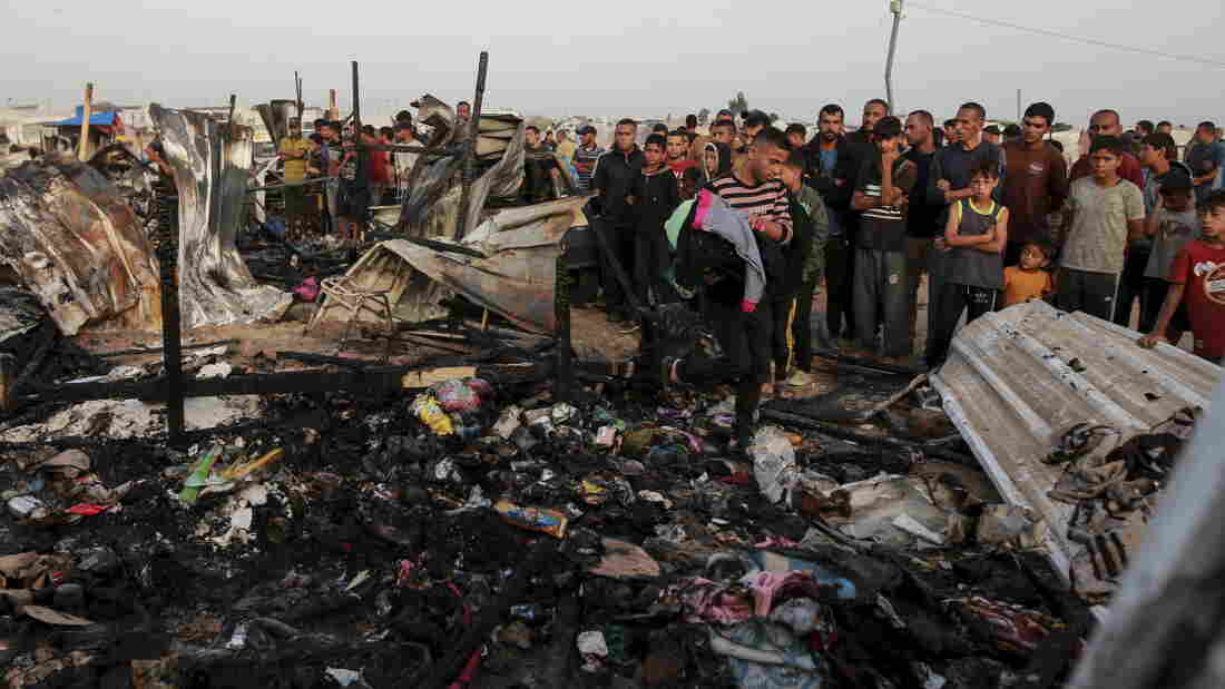 Palestinians look at the destruction after an Israeli strike where displaced people were staying in Rafah, Gaza Strip, Monday, May 27, 2024.