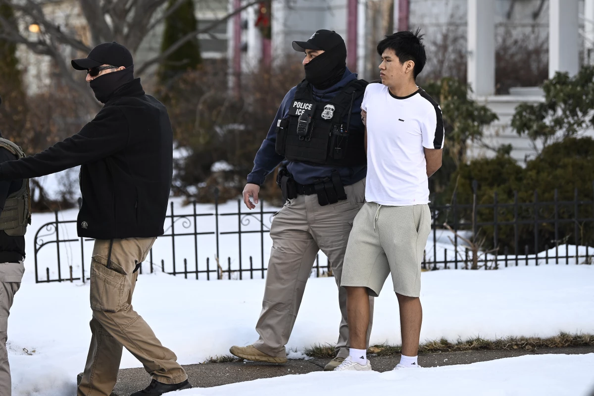 ICE agents detain a person on January 13, 2026 in Minneapolis. Arrests, detainments and deportations in Minnesota, Illinois and other states have engendered fear in immigrant communities, including among people with legal status.