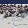 The U.S. men's sled hockey team players celebrate with the gold medals after the ice hockey match between USA' and Canada at the Milano Cortina 2026 Paralympic Winter Games in Milan on March 15, 2026. (Photo by Stefano RELLANDINI / AFP via Getty Images)