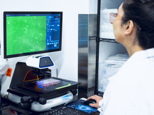 Tie examines cells carrying a genetic mutation that increases the risk for breast cancer that have been injected with one of Origin's experimental gene editors.