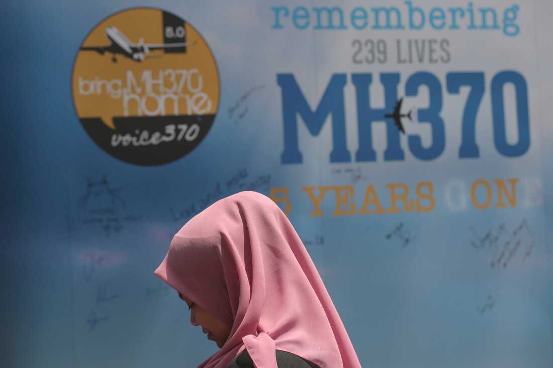 A girl stands in front of a condolence message board during the Remembrance Day for MH370 event in Kuala Lumpur, Malaysia, March 3, 2019.