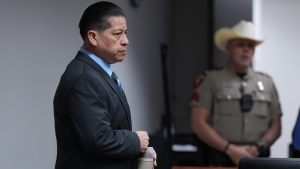 Former Uvalde school district police officer Adrian Gonzales arrives in the courtroom at the Nueces County Courthouse in Corpus Christi, Texas, on Tuesday.