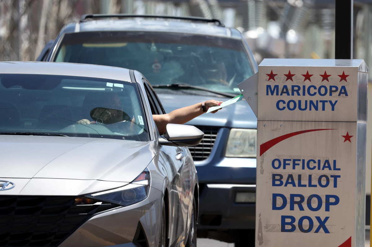 A voter places a ballot in a drop box outside of the Maricopa County Elections Department on Aug. 2, 2022 in Phoenix. A records flaw risks blocking nearly 100,000 people from voting in state and local races in Arizona in the upcoming elections.