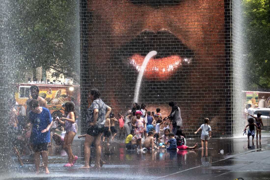 People cool off at the fountain in Millennium Park in Chicago as temperatures topped 90 degrees on Monday.