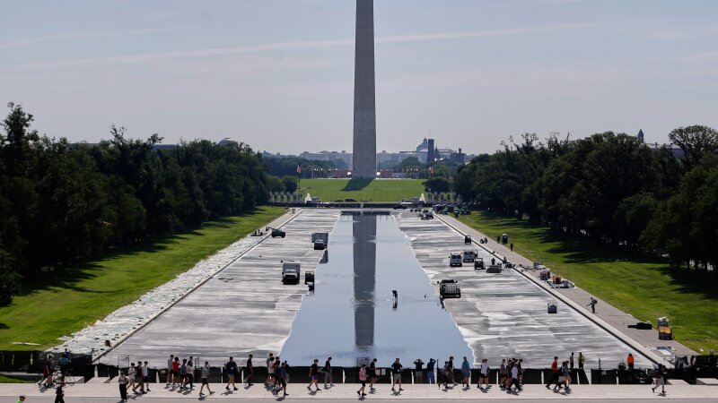 Workers refill the Lincoln Memorial Reflecting Pool on Friday, after weeks of resurfacing.