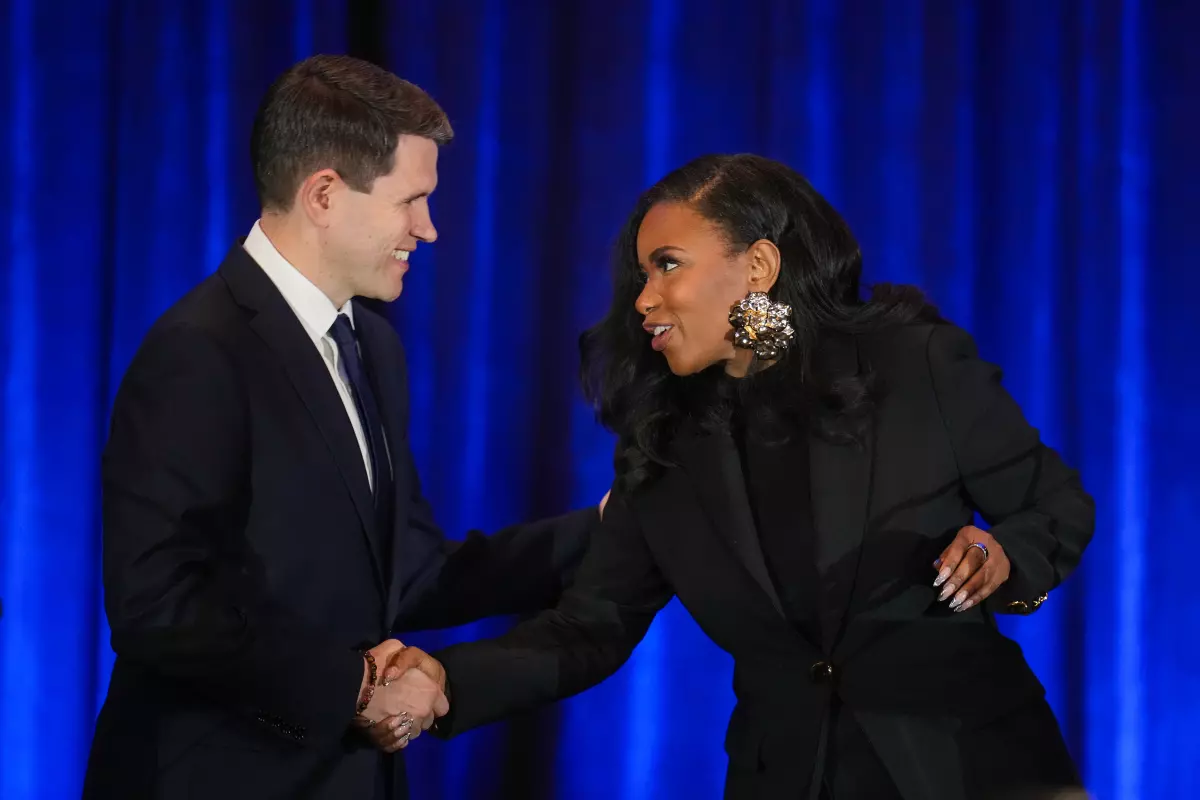 State Rep. James Talarico, left, and U.S. Rep. Jasmine Crockett, Democratic primary candidates for U.S. Senate, shake hands prior to a debate at the Texas AFL-CIO COPE Convention in Georgetown on Saturday, Jan. 24, 2026.