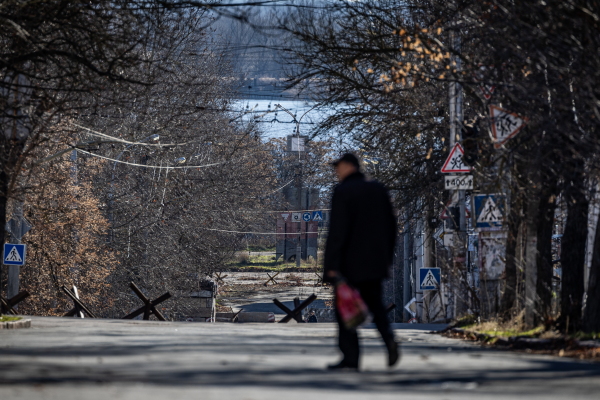 Man walking down the street with hedgehogs and river Dnipro on the background.