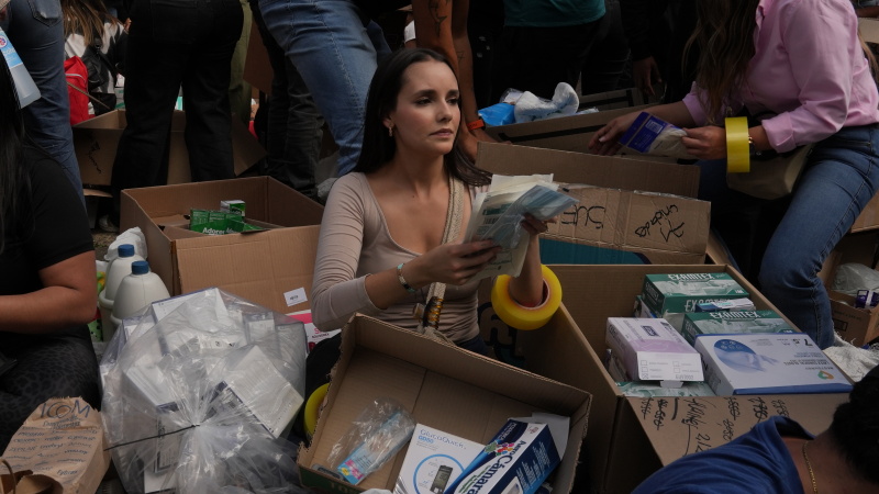Outside a community center in Bogota, volunteers load boxes with clothes and food onto a truck that will take supplies to victims of Venezuela's earthquake.
