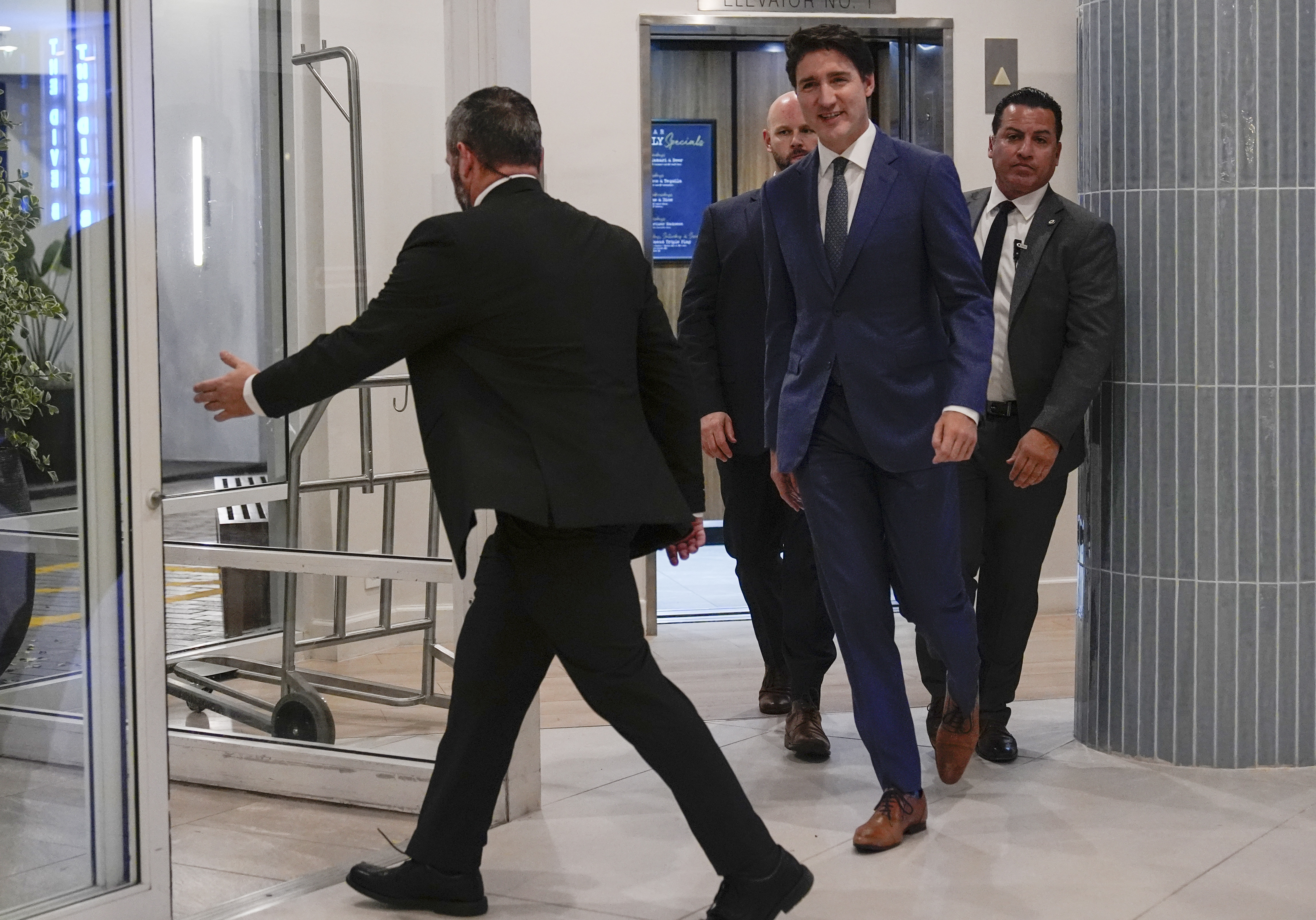 Canadian Prime Minister Justin Trudeau walks through the lobby of the Delta Hotel by Marriott, on Friday, in West Palm Beach, Fla.