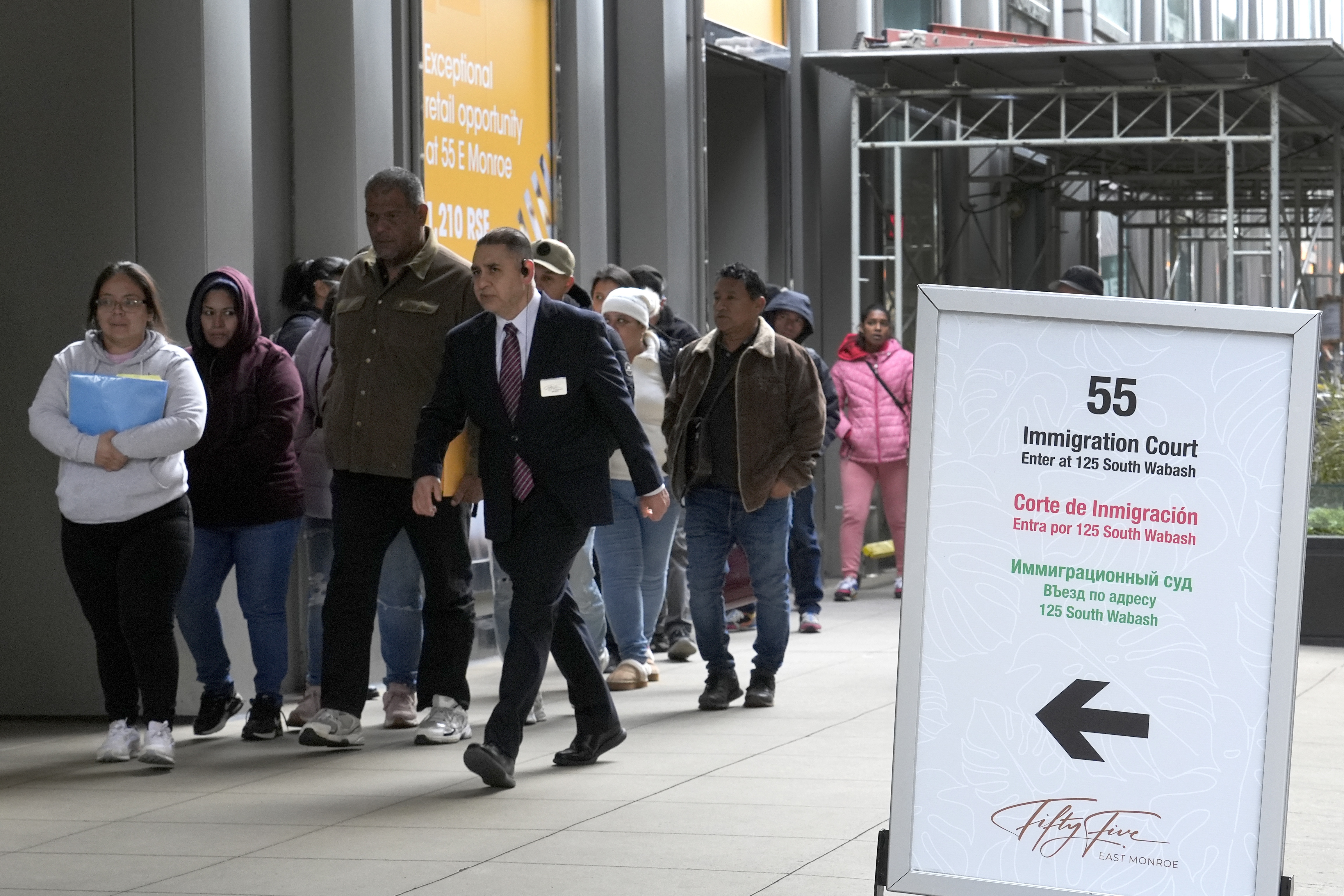 After waiting in a queue, people are led into a downtown Chicago building where an immigration court presides, Nov. 12, 2024. (AP)