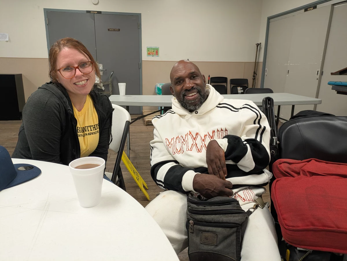 Dr. Elyse Stevens, left, attends a community breakfast at a New Orleans nonprofit, with her former patient Ronald Major who says Stevens treated him like family.