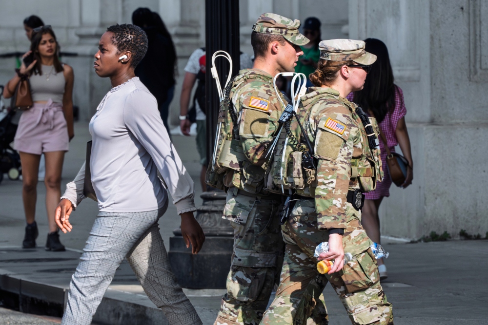 National Guard personnel keep watch as travelers arrive at the entrance to Union Station near the Capitol, in Washington, D.C., on Thursday, Aug. 14, 2025. (AP)