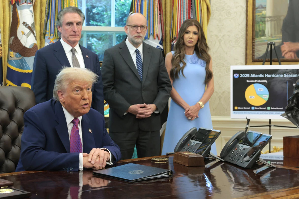 OMB Director Russell Vought (center, behind President Trump) is the lead plaintiff in a lawsuit brought by four state attorneys general over more than $600 million in cuts to CDC grants announced this week. Homeland Security Sec. Kristi Noem and Interior Sec. Doug Burgum are also pictured in the Oval Office in June 2025.