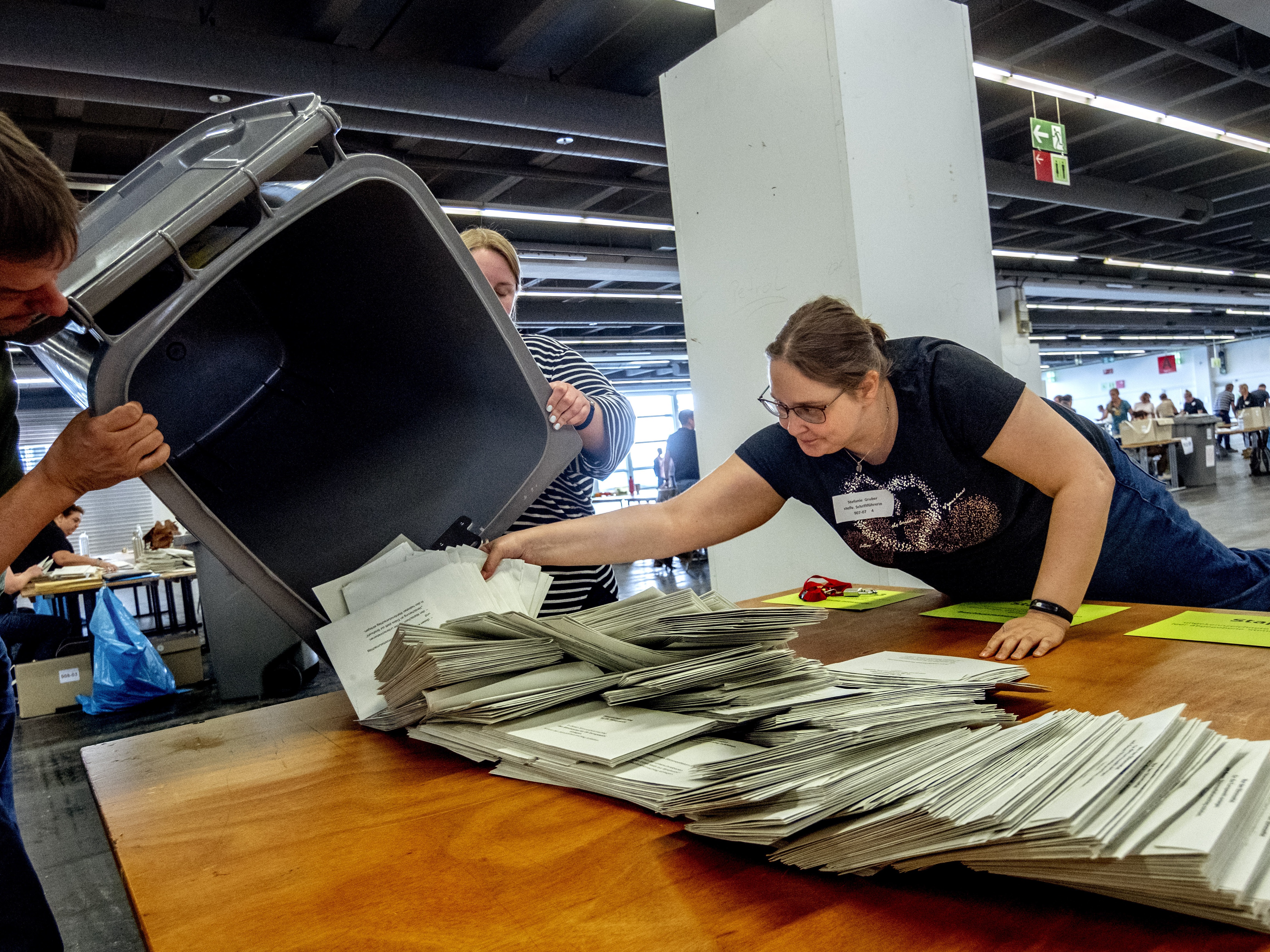 Elections workers empty a bin to count postal ballots for the European Union elections in Frankfurt, Germany, on Sunday. (AP)