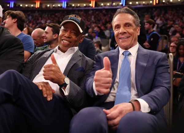 Eric Adams (left) poses with Andrew Cuomo during the game between the New York Knicks and the Cleveland Cavaliers at Madison Square Garden on October 22.