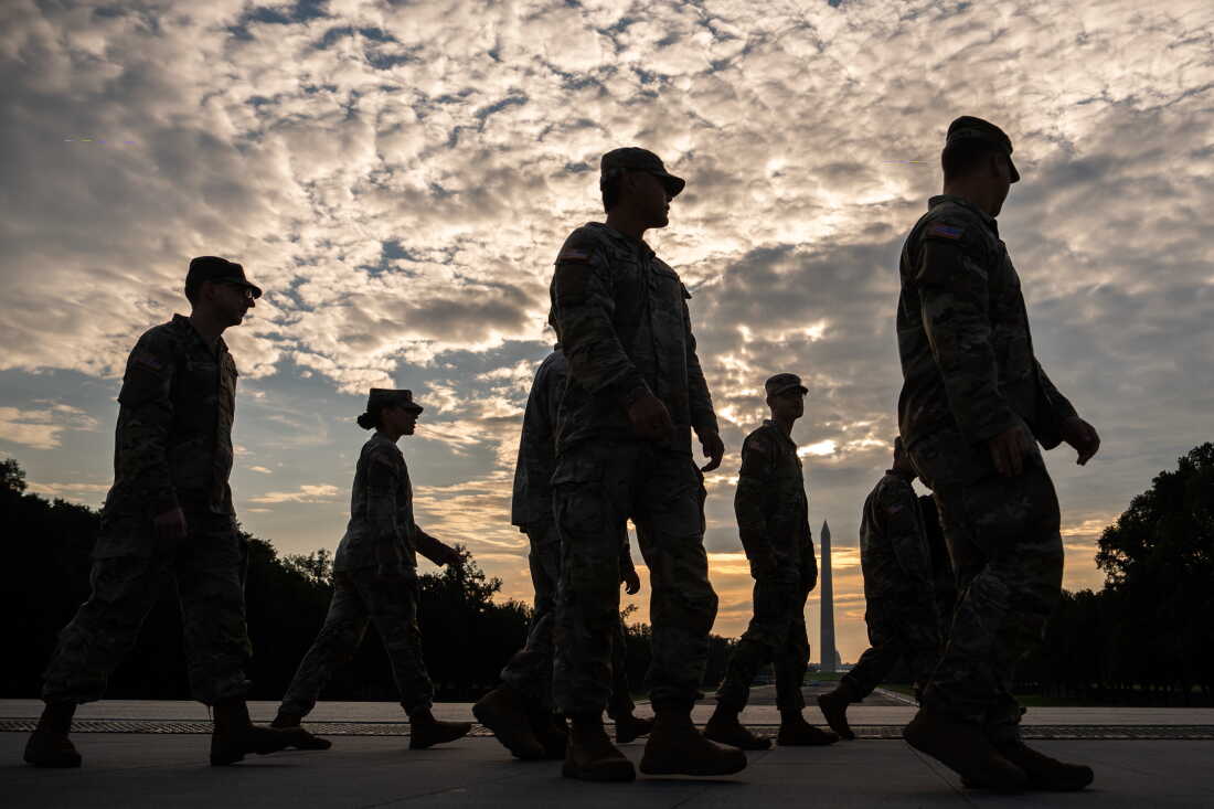 Members of the National Guard walk past the Lincoln Memorial Reflecting Pool before the March on Washington, Friday, Aug. 28, 2026, in Washington.