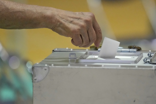 A voter casts a ballot in the upper house elections at a polling station Sunday, July 20, 2025, in Tokyo. (AP Photo/Eugene Hoshiko)