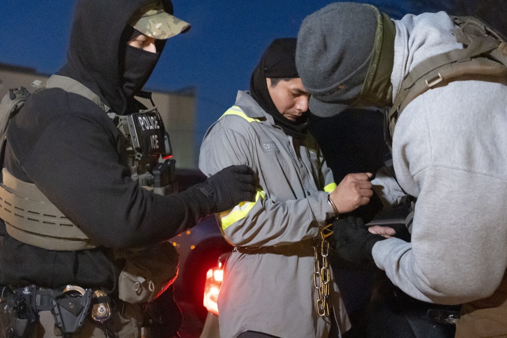 U.S. Immigration and Customs Enforcement officers use a chain to more comfortably restrain a detained person using handcuffs positioned in front. (AP)