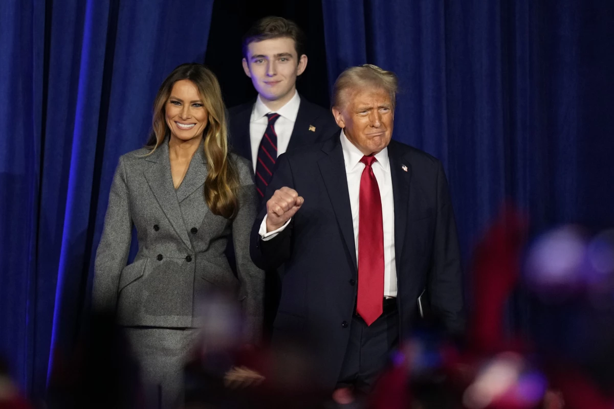 Republican presidential nominee former President Donald Trump, joined by Melania Trump, left, and Barron Trump, arrives to speak at an election night watch party on Nov. 6, 2024, in West Palm Beach, Fla.
