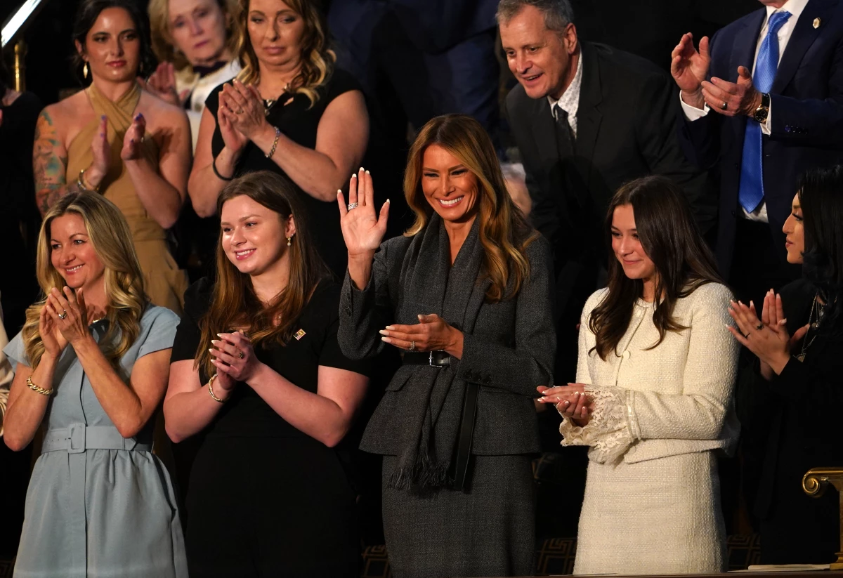 First Lady Melania Trump (center) waves as she attends US President Donald Trump's address to a joint session of Congress in the House Chamber of the Capitol.