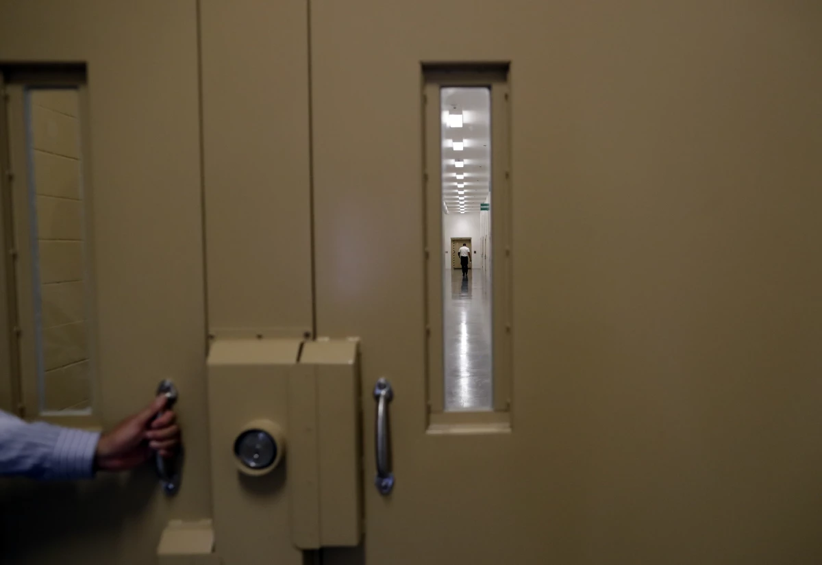 A man walks in a hallway at the Otay Mesa Detention Center Wednesday, Aug. 23, 2017, in San Diego.