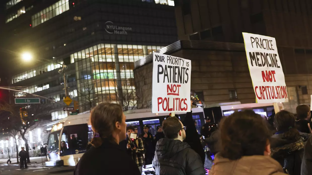 People in favor of healthcare for transgender youth march outside NYU Langone hospital in New York City in February 2025.