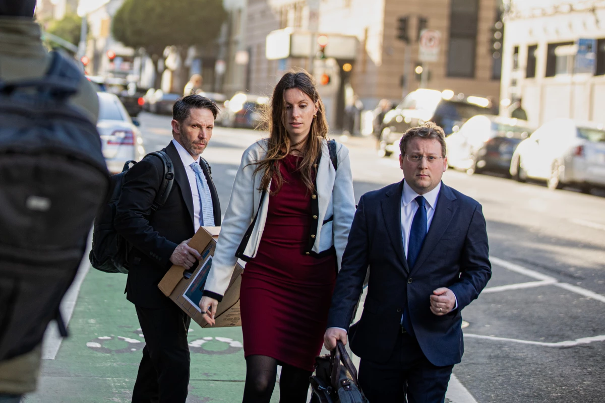 Members of Elon Musk's legal team, including attorney Michael Lifrak (left), exit the Phillip Burton Federal Building in San Francisco on March 4.