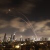 Israeli air defense systems fire to intercept Iranian missiles over Tel Aviv before dawn Wednesday. Israel and Iran exchanged fire for a sixth day.