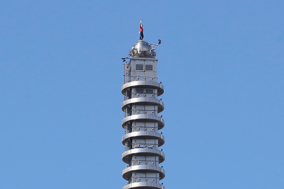 Rock climber Alex Honnold, of the U.S., raises his fist as he climbs on top of the Taipei 101 skyscraper in Taipei, Taiwan, Sunday, Jan. 25, 2026.