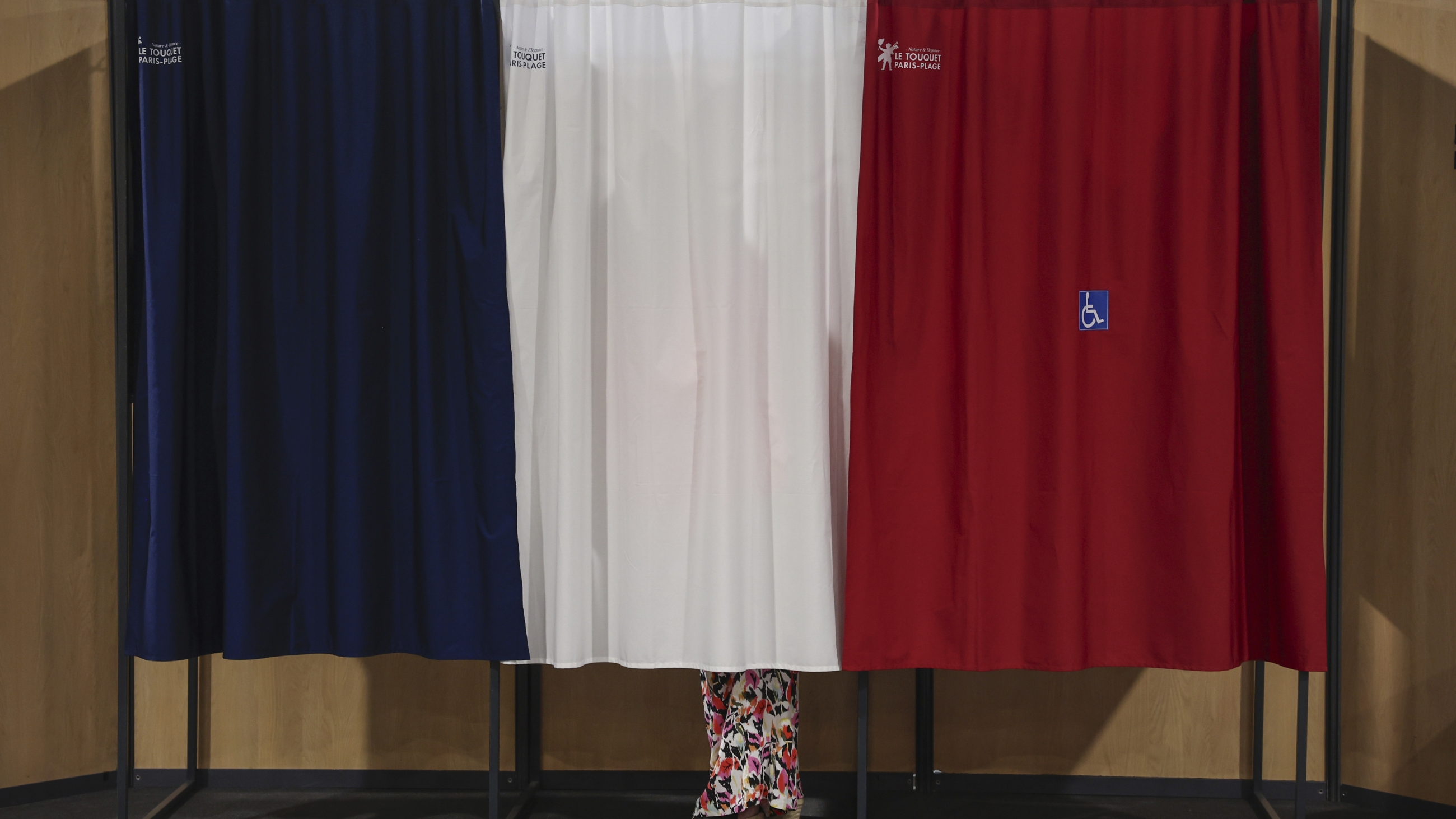 A voter stands in the polling booth during the second round of the legislative elections in Le Touquet-Paris-Plage, northern France, on Sunday.