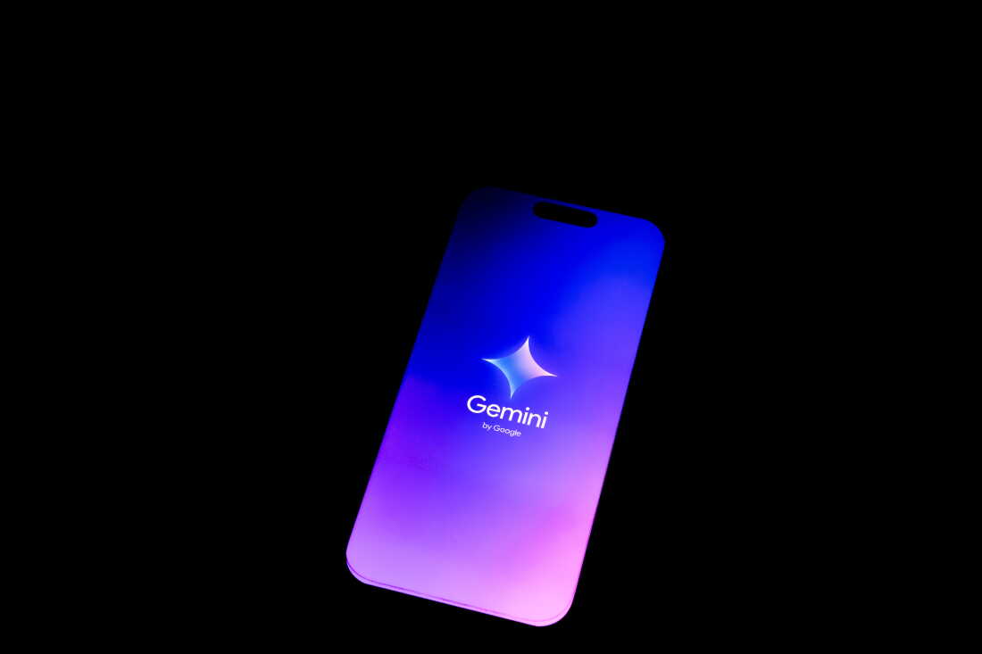 A smartphone screen displaying the Gemini mobile application logo by Google on a dark background.
