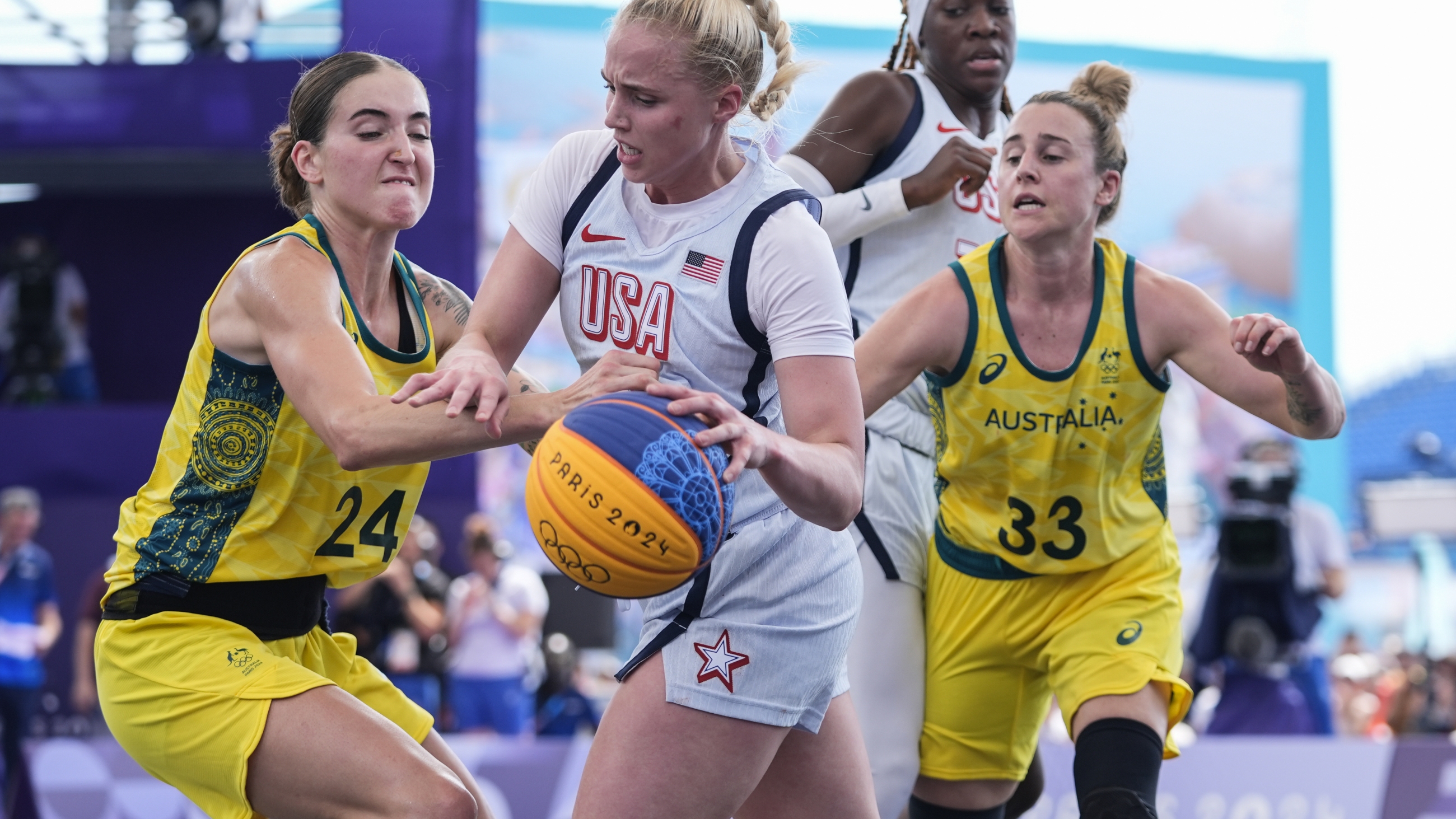 Australia's Anneli Maley (24) and Lauren Mansfield (33) defend Hailey van Lith, of the United States, in the women's 3x3 basketball pool round match during the 2024 Summer Olympics, on Thursday in Paris. Australia won 17-15.