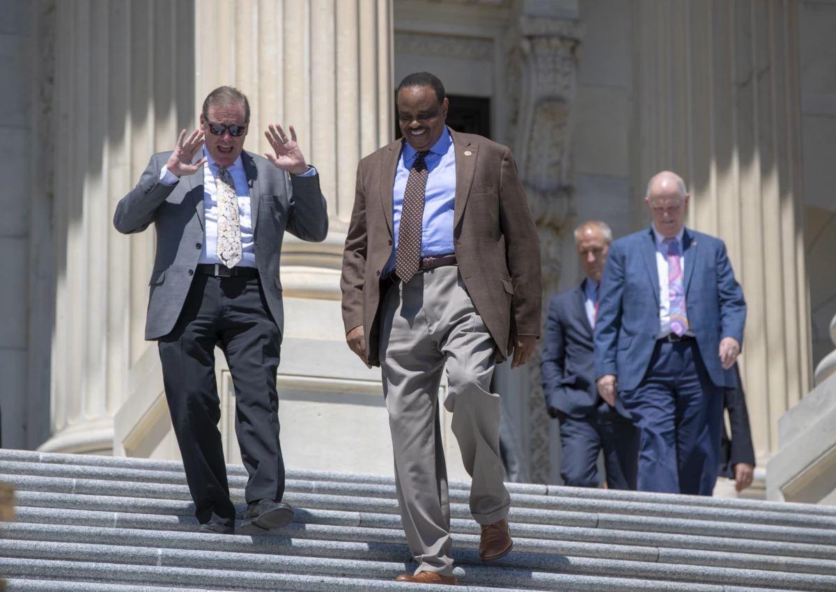 Rep. Neal Dunn, R-Fla., left, and former Rep. Al Lawson, D-Fla., center, are seen exiting the Capitol in Washington on June 15, 2018. After redistricting changed Florida's congressional districts, Dunn defeated Lawson in the 2022 election.