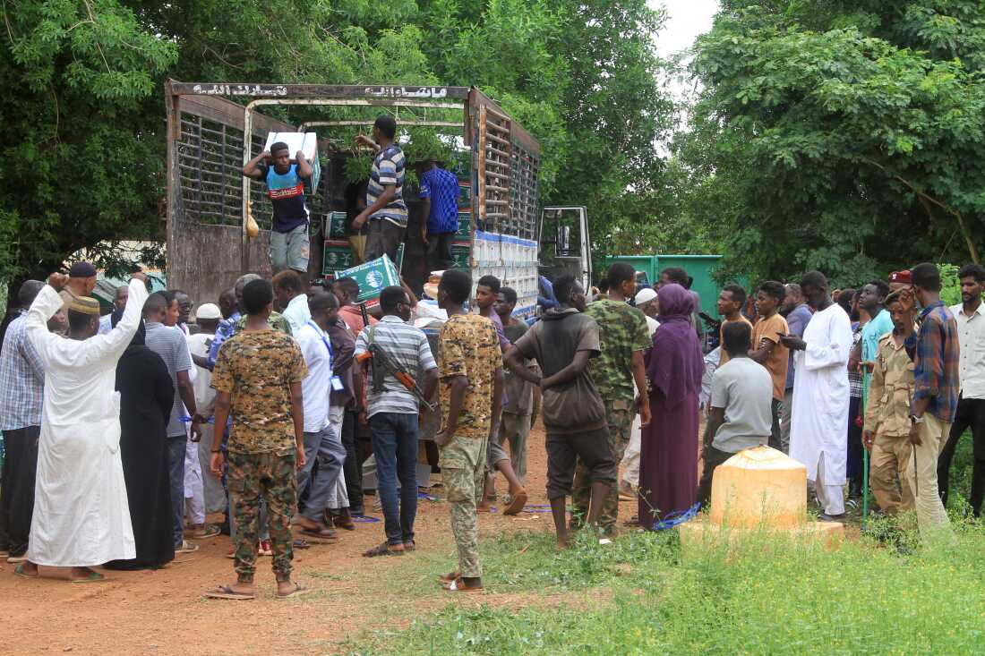 Sudanese, who have recently returned from being displaced, queue to receive humanitarian aid in Ombada, west of Omdurman on August 24, 2025. The Sudanese army, at war with the paramilitary Rapid Support Forces (RSF) since April 2023, recaptured Khartoum state in May, but widespread hunger continues to grip the heart of Africa's third-largest country.