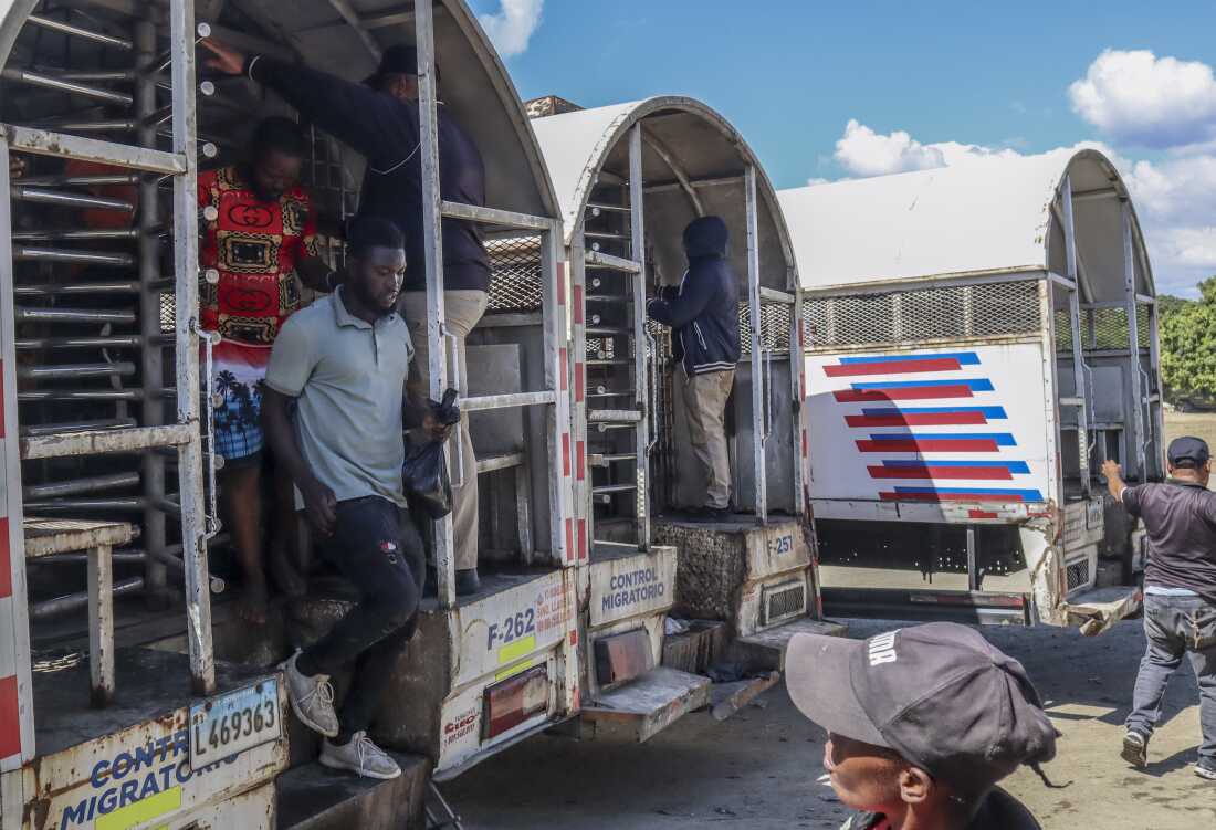 Haitians deported from the Dominican Republic get out of trucks in Carrizal, Dominican Republic, on the border with Haiti on Jan. 30.