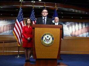 House Speaker Mike Johnson, R-La., addresses reporters as Rep. Lisa McClain, R-Mich., and Majority Leader Steve Scalise, R-La., look on during a news conference Tuesday ahead of the government funding vote.