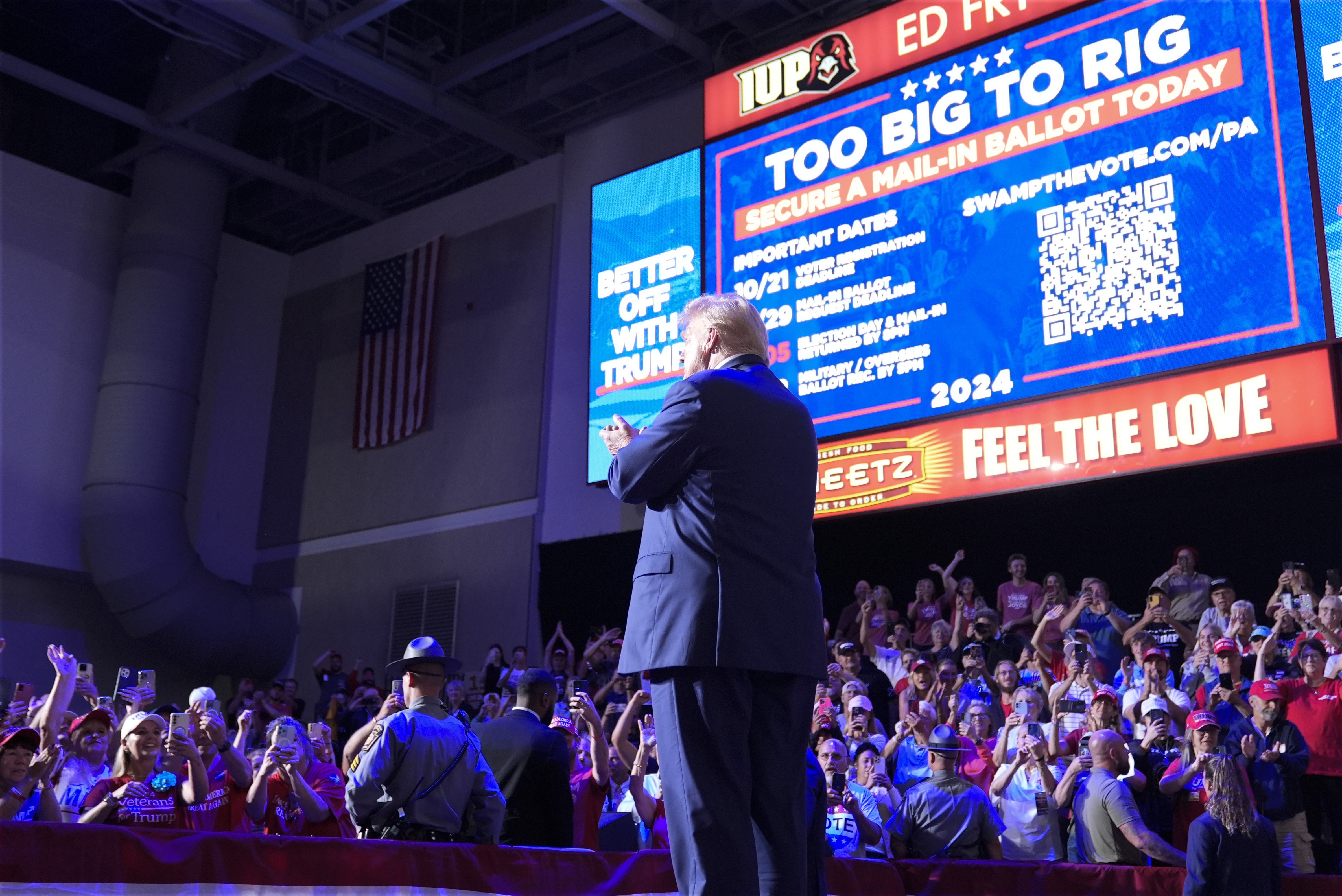 Former President Donald Trump stands on stage after speaking at a campaign event in Indiana, Pa., on Sept. 23. Behind Trump, Republicans are urged to vote in numbers that are "too big to rig." (AP)
