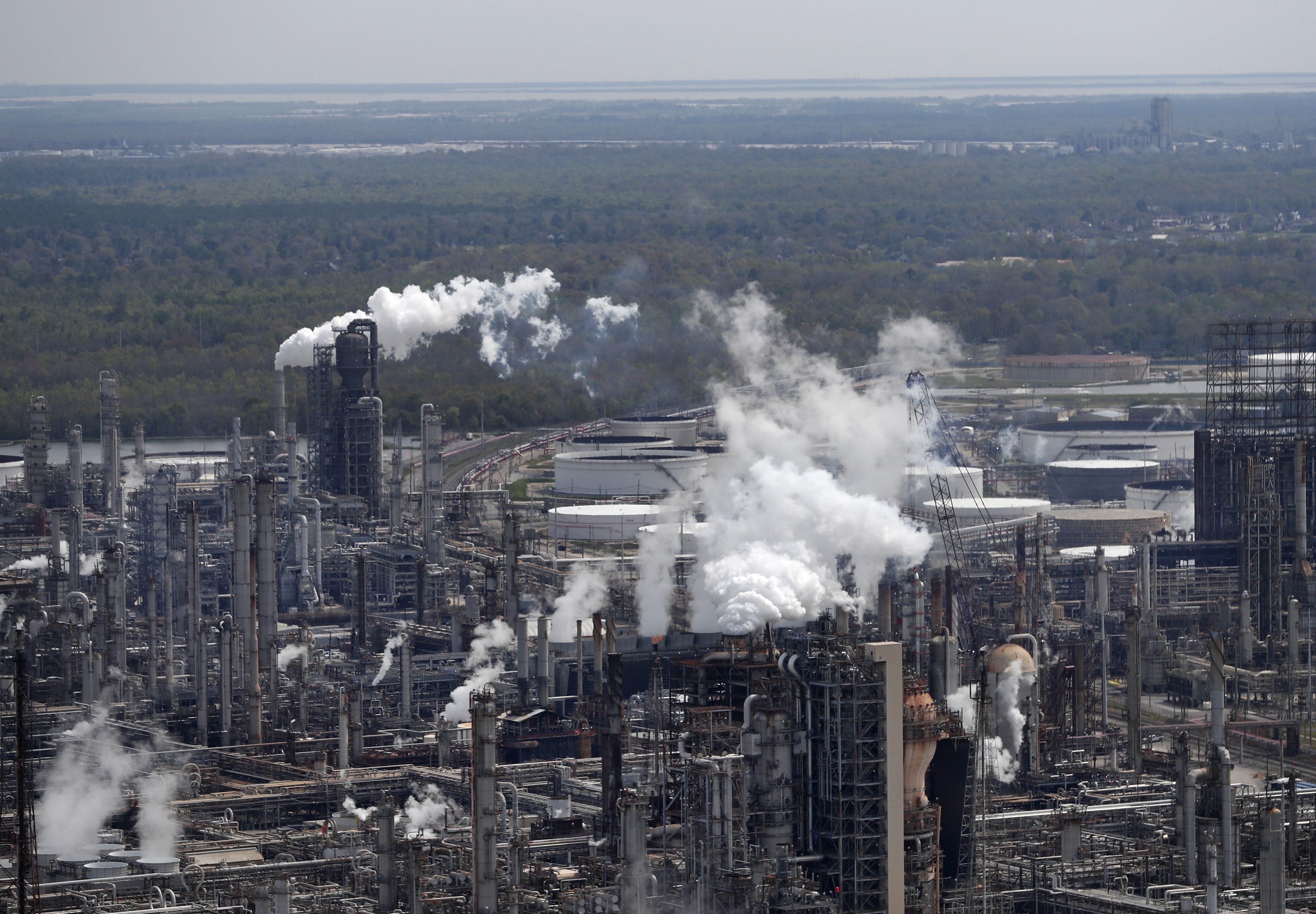 Wetlands are seen beyond a refinery in Norco, La.