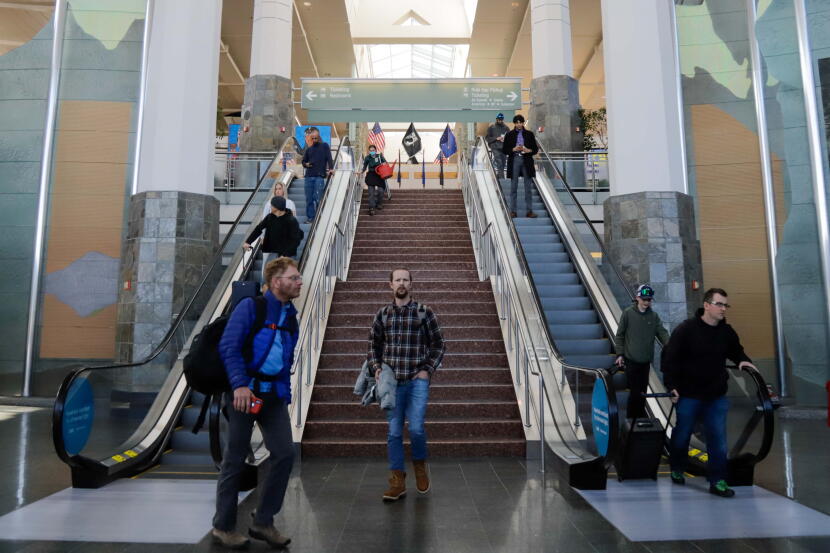 Passengers arrive at the Ted Stevens Anchorage International Airport on April 20, 2022.