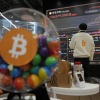 FILE - An employee watches an electronic signboard displaying the prices of Bitcoin and other cryptocurrencies at the lounge of Bithumb cryptocurrency exchange in Seoul, South Korea, Nov. 21, 2024.