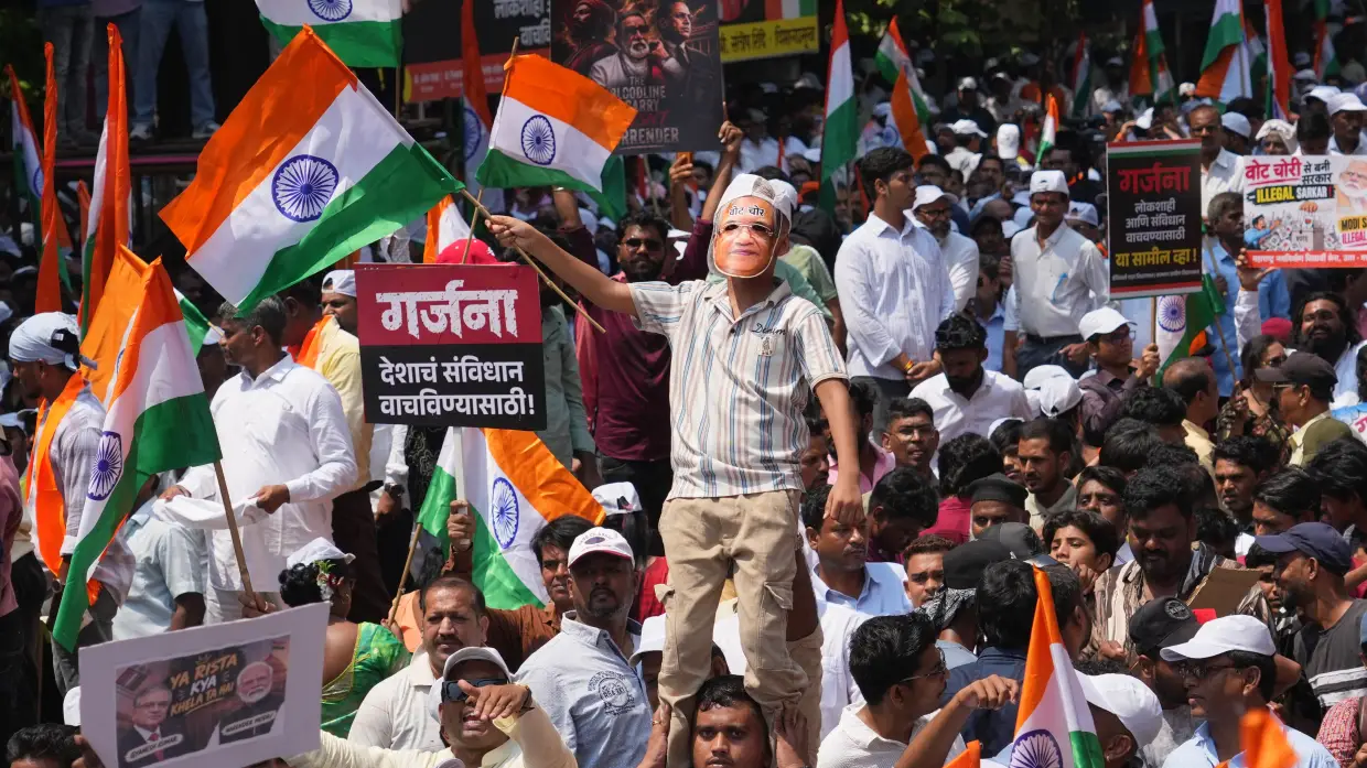 A protester wears a mask depicting Chief Election Commissioner Gyanesh Kumar with the words "vote theft" during a protest organized by Shiv Sena (UBT) and the Maharashtra Navnirman Sena , demanding his resignation and the suspension of the Special Intensive Revision (SIR) of electoral rolls, in Mumbai, India, Sunday, Oct. 4, 2026.