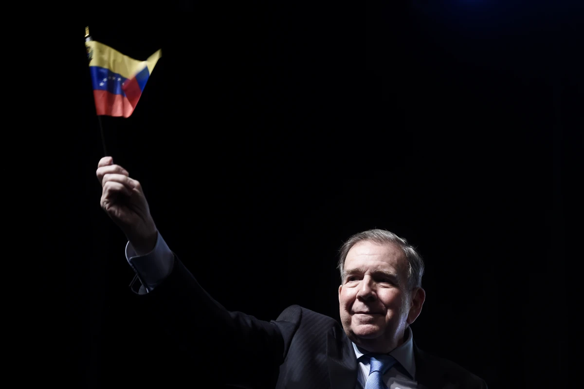 Venezuela's opposition leader Edmundo Gonzalez waves a Venezuelan flag during a meeting with supporters in Panama City, Wednesday, Jan. 8, 2025