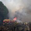 Firefighters tackle a blaze as wildfires rage near Le Las, outside Bordeaux, France, Monday, July 27, 2026.