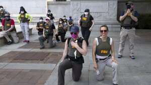 FBI personnel take a knee with demonstrators that were marching on Pennsylvania Avenue in Washington, D.C., on June 4, 2020, during a protest over the death of George Floyd.